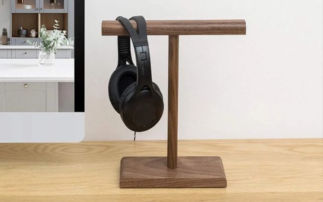 A wooden headset stand